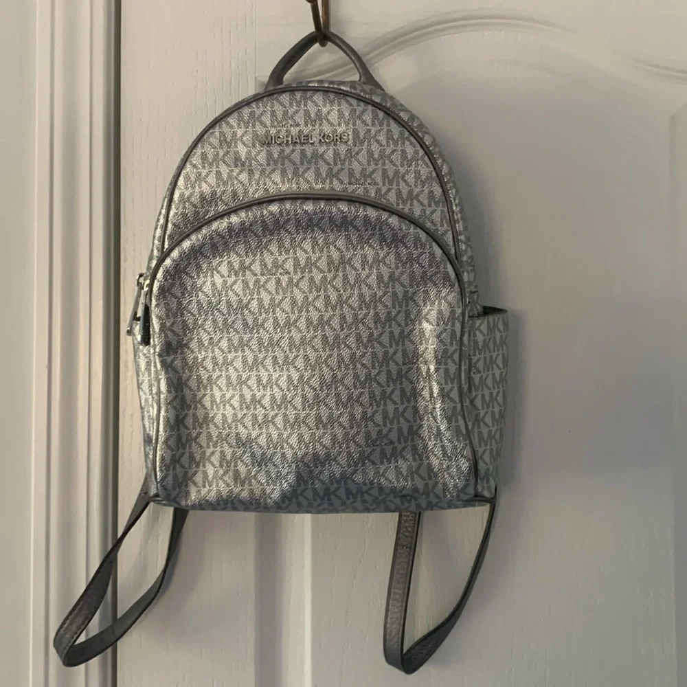 Michael Kors Silver shimmer Monogram Backpack shiny zipper leather compartments‎
